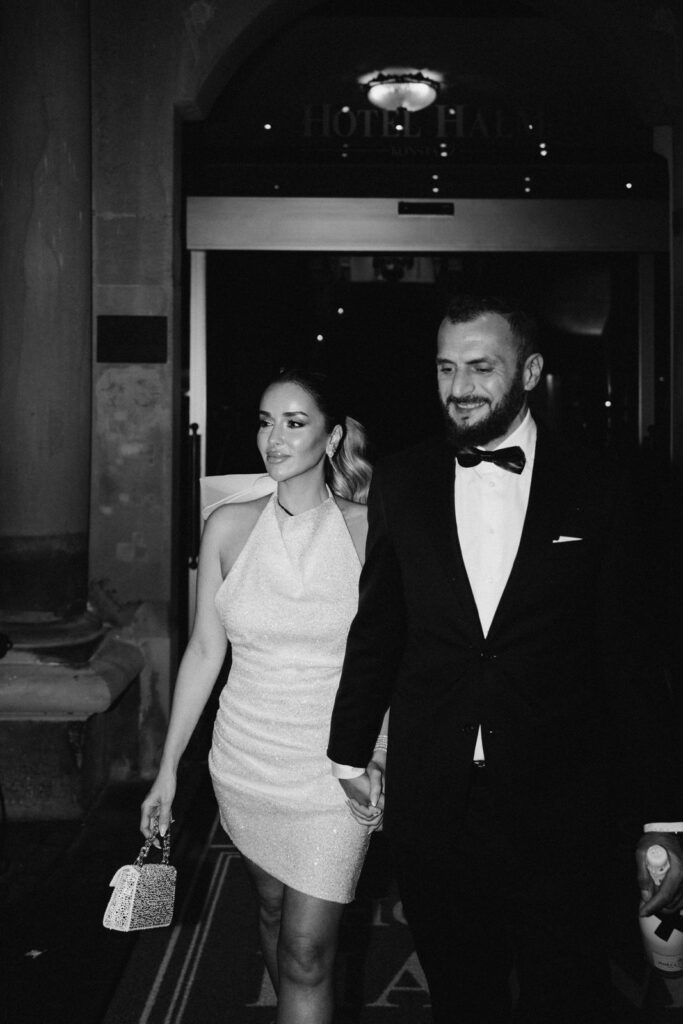 bride and groom walking hand in hand in a modern setting