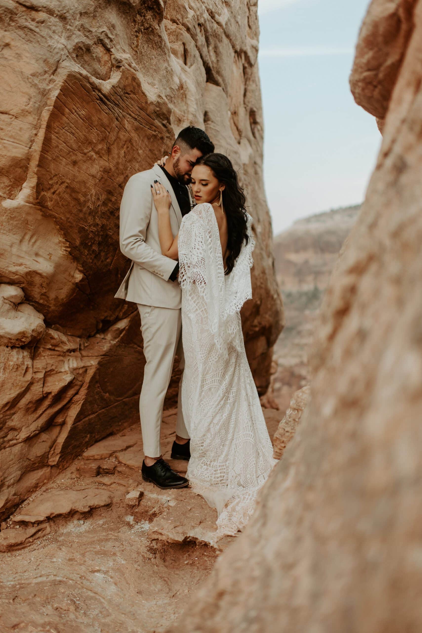 Couple standing on rock during adventurous elopement