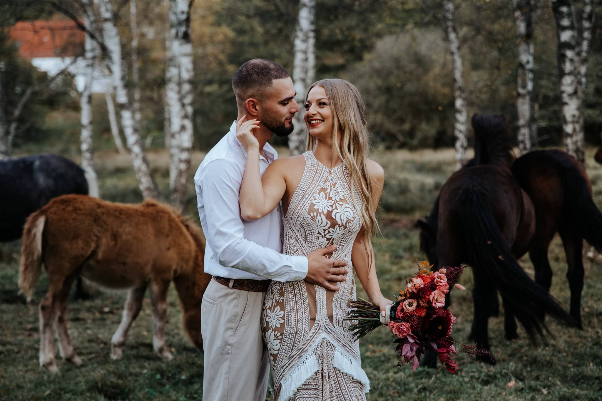 Editorial wedding couple with horses